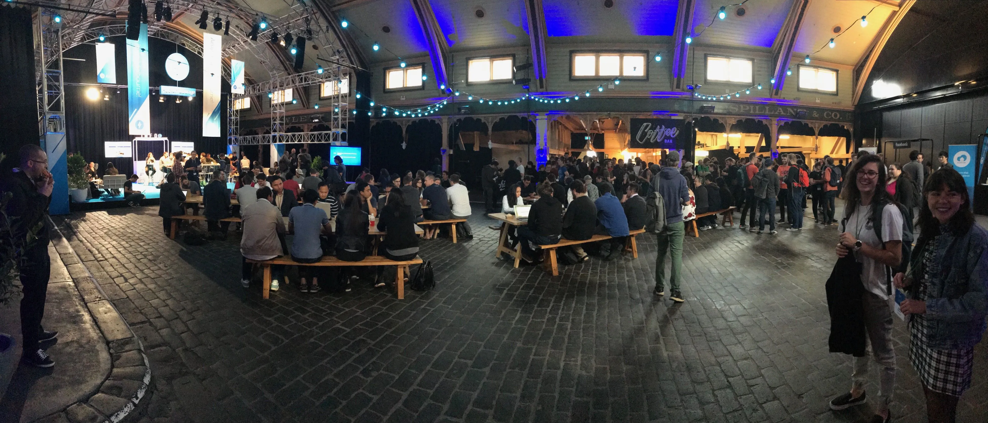 JSConf-goers enjoying the complimentary coffee on the first day of the event (and some cheery Abletechers on the right!)